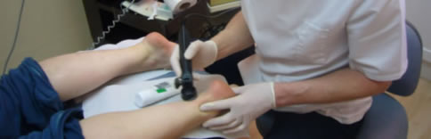 The athlete is receiving ultrasound therapy on her Achilles tendon